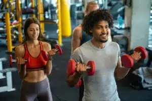 People working out together in a gym using weights